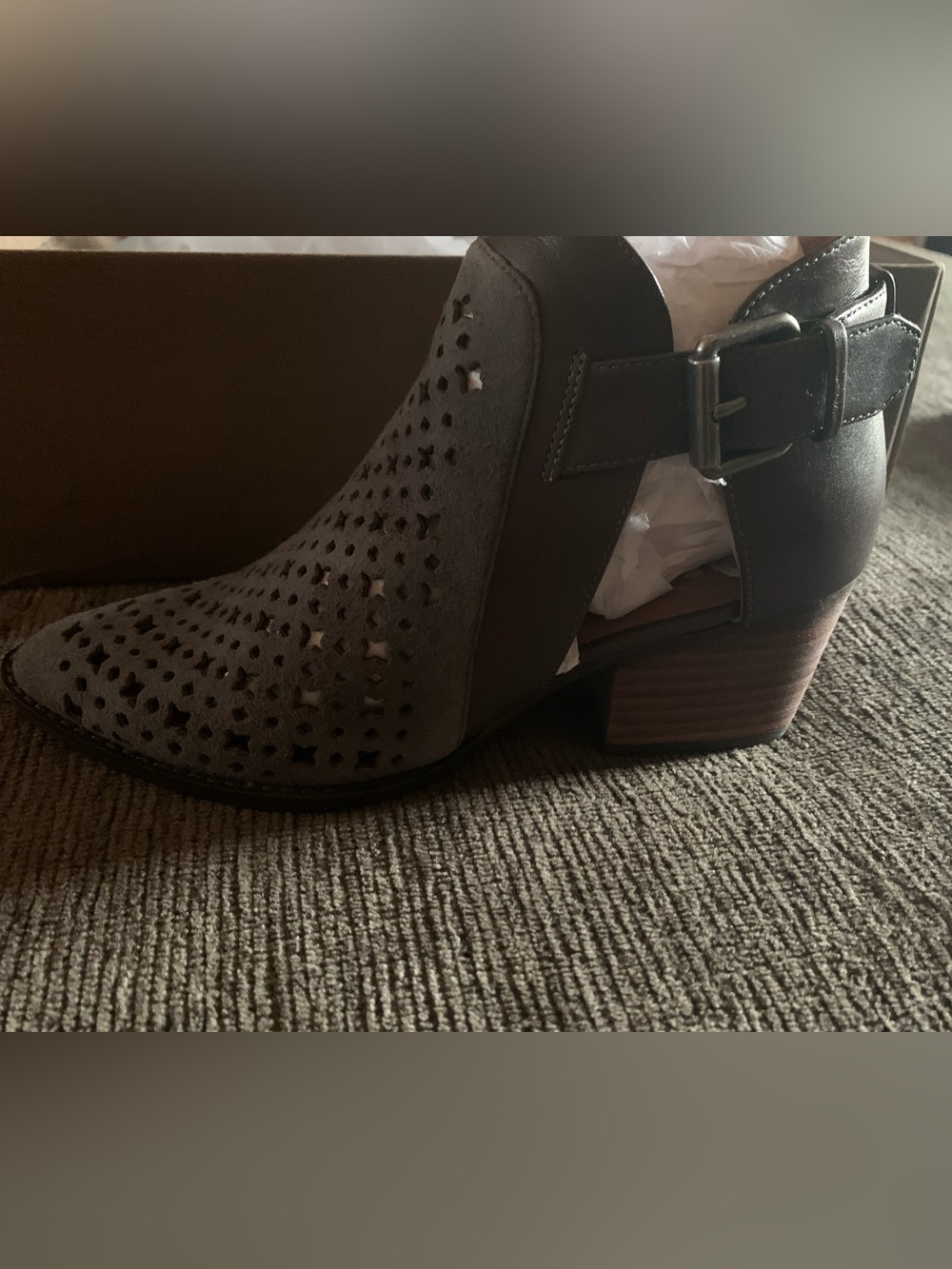 Linea Paolo low stacked-heel ankle bootie features a distinctive laser-cut